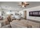 Bright living room with hardwood floors and neutral paint extends into a kitchen and dining area at 6329 Sterling Ranch Way, North Las Vegas, NV 89081