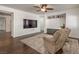 Comfortable living room with hardwood floors, recessed lighting, a large television, and built in storage at 6329 Sterling Ranch Way, North Las Vegas, NV 89081