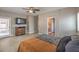 Spacious main bedroom with fan, light wood floors, and access to balcony at 6329 Sterling Ranch Way, North Las Vegas, NV 89081