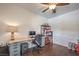 Bright home office with hardwood floors, ceiling fan and generous built-in desk and storage at 6329 Sterling Ranch Way, North Las Vegas, NV 89081