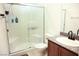 Modern bathroom with a glass-enclosed shower, granite countertop, and vanity at 645 Turtleback Falls Ave, Indian Springs, NV 89018