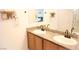 Modern bathroom featuring dual sinks, granite countertops, and matching vanities at 645 Turtleback Falls Ave, Indian Springs, NV 89018
