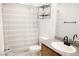 Bathroom with a shower and tub, granite countertop, modern sink, and shelving at 645 Turtleback Falls Ave, Indian Springs, NV 89018
