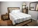 Comfortable bedroom with a queen-sized bed, stylish nightstands, and a mirror at 645 Turtleback Falls Ave, Indian Springs, NV 89018