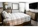 Comfortable bedroom boasts a bed with a stylish black and white comforter and wood bedside tables at 645 Turtleback Falls Ave, Indian Springs, NV 89018