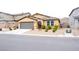Charming single-story home with a tile roof, gravel yard, and a gray two-car garage at 645 Turtleback Falls Ave, Indian Springs, NV 89018
