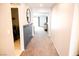 Hallway with carpeted floors and neutral walls, leading to the living area and laundry room at 645 Turtleback Falls Ave, Indian Springs, NV 89018