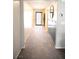 Hallway with carpeted floors and light gray walls, offering views to the entryway and other rooms at 645 Turtleback Falls Ave, Indian Springs, NV 89018