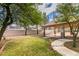 Spacious backyard with a covered patio, grassy area, and mature trees, perfect for outdoor living at 6582 Cartgate Ct, Las Vegas, NV 89110