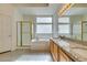 Well-appointed bathroom with a large tub, glass-enclosed shower, and dual vanity with granite counters at 6582 Cartgate Ct, Las Vegas, NV 89110