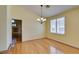 Dining room with chandelier, wood floors, and window shutters at 6582 Cartgate Ct, Las Vegas, NV 89110