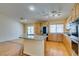 Bright open kitchen features stainless appliances, granite counters and wood floors at 6582 Cartgate Ct, Las Vegas, NV 89110
