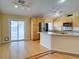 Bright kitchen features wood floors, granite counters, stainless appliances and sliding door to backyard at 6582 Cartgate Ct, Las Vegas, NV 89110