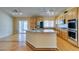 Spacious kitchen has stainless appliances, granite counters, wood floors and breakfast bar at 6582 Cartgate Ct, Las Vegas, NV 89110