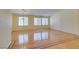 Sunlit living room with gleaming hardwood floors and plantation shutters at 6582 Cartgate Ct, Las Vegas, NV 89110