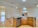 View of the living room with breakfast bar, light wood floors and fireplace at 6582 Cartgate Ct, Las Vegas, NV 89110