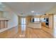 Open-concept living room with a fireplace, hardwood flooring, and large sliding glass doors at 6582 Cartgate Ct, Las Vegas, NV 89110
