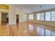 Bright living room with vaulted ceiling, fireplace, wood floors, and window shutters at 6582 Cartgate Ct, Las Vegas, NV 89110