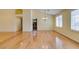 Bright living room with vaulted ceiling, wood floors, and window shutters at 6582 Cartgate Ct, Las Vegas, NV 89110