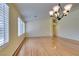 Bright living room with chandelier, wood floors, and window shutters at 6582 Cartgate Ct, Las Vegas, NV 89110