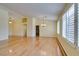 Bright living room with vaulted ceiling, wood floors, and window shutters at 6582 Cartgate Ct, Las Vegas, NV 89110