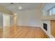 Living room showcasing a fireplace, vaulted ceilings, and hardwood flooring at 6582 Cartgate Ct, Las Vegas, NV 89110