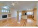 Open-concept living room with a fireplace, a kitchen island, and sliding glass doors at 6582 Cartgate Ct, Las Vegas, NV 89110