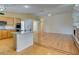 Open-concept floor plan features light wood floors, kitchen with breakfast bar and fireplace at 6582 Cartgate Ct, Las Vegas, NV 89110