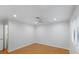 This bedroom has wood floors, a fan, and a window at 6733 W Charleston Blvd # 3, Las Vegas, NV 89146