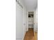 This hallway features neutral walls, interior doors, and a storage closet with shelves for ample storage at 6733 W Charleston Blvd # 3, Las Vegas, NV 89146