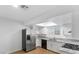 Well-lit kitchen with white cabinets, stainless steel refrigerator, and updated appliances for modern living at 6733 W Charleston Blvd # 3, Las Vegas, NV 89146