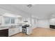 Updated kitchen featuring granite countertops and stainless steel oven, seamlessly flowing into an adjacent living area at 6733 W Charleston Blvd # 3, Las Vegas, NV 89146