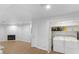 Well-lit laundry area with washer, dryer, storage shelves, fireplace, and ample open floor space at 6733 W Charleston Blvd # 3, Las Vegas, NV 89146