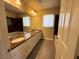 Bright bathroom features a dual sink vanity with granite countertops and ample storage at 6778 Goose Watch Ct, Las Vegas, NV 89139
