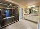 Elegant bathroom with glass enclosed shower, dual mirrors and vanity at 6778 Goose Watch Ct, Las Vegas, NV 89139