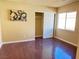 Bedroom with hardwood floors includes closet with sliding doors and natural light at 6778 Goose Watch Ct, Las Vegas, NV 89139