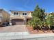 Charming two-story home featuring a brick driveway, stone accents, and mature landscaping at 6778 Goose Watch Ct, Las Vegas, NV 89139