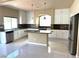 Stylish kitchen featuring white cabinets, granite countertops, a center island, and stainless steel appliances at 6778 Goose Watch Ct, Las Vegas, NV 89139