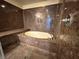 Luxurious tiled shower with built-in bench and modern fixtures at 6778 Goose Watch Ct, Las Vegas, NV 89139