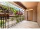 A private balcony featuring black metal railings and an outdoor storage closet with views of the community landscaping at 6868 Sky Pointe Dr # 1122, Las Vegas, NV 89131