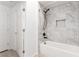 Clean bathroom featuring a shower-tub combination with tile walls and a white tub at 6868 Sky Pointe Dr # 1122, Las Vegas, NV 89131