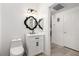 Bright bathroom features decorative mirror and white vanity with fixtures at 6868 Sky Pointe Dr # 1122, Las Vegas, NV 89131