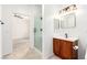 Well-lit bathroom with vanity, glass shower, and wood cabinet at 6868 Sky Pointe Dr # 1122, Las Vegas, NV 89131