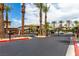 A gated entrance with palm trees lining the street offers privacy and security to this community at 6868 Sky Pointe Dr # 1122, Las Vegas, NV 89131