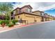A townhouse exterior with well-kept landscaping and a nearby fire hydrant, displaying curb appeal and safety features at 6868 Sky Pointe Dr # 1122, Las Vegas, NV 89131