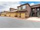Townhouse exterior showcasing a row of units with attached garages and staircase access, offering convenient parking and entry at 6868 Sky Pointe Dr # 1122, Las Vegas, NV 89131