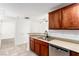 Well-lit kitchen with stainless steel dishwasher, wood cabinets, and breakfast bar at 6868 Sky Pointe Dr # 1122, Las Vegas, NV 89131