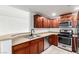 Kitchen features stainless steel appliances, dark wood cabinets, and breakfast bar at 6868 Sky Pointe Dr # 1122, Las Vegas, NV 89131