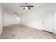 Open-concept living room with tiled floors, a ceiling fan, and views into the kitchen at 6868 Sky Pointe Dr # 1122, Las Vegas, NV 89131