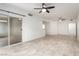 Expansive living room featuring sleek sliding doors, multiple ceiling fans, and a convenient breakfast bar at 6868 Sky Pointe Dr # 1122, Las Vegas, NV 89131